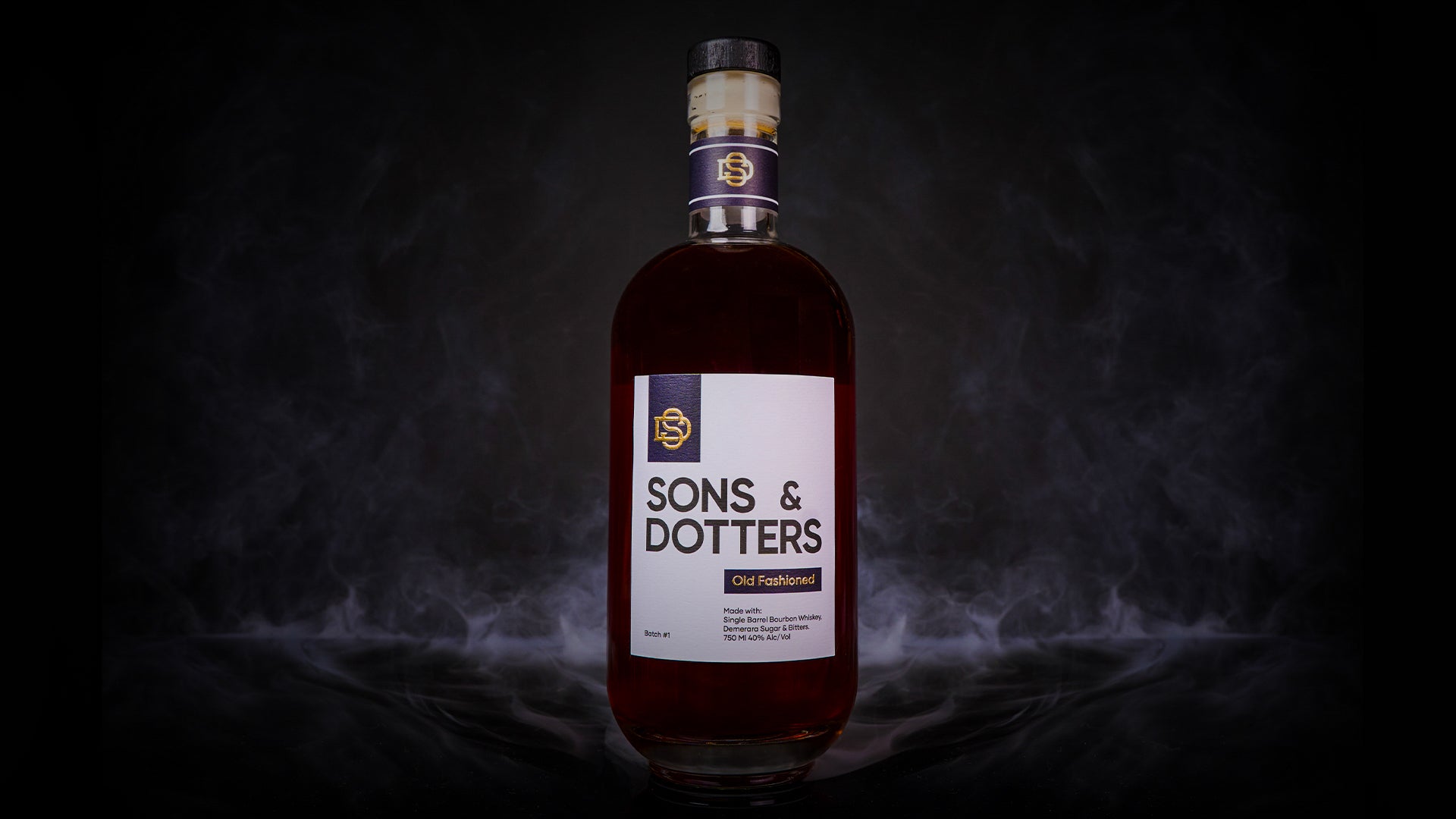 a bottle of Sons & Dotters Old Fashioned on a black background with a misty smoke behind it